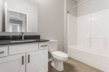 a bathroom with a toilet and a sink and a shower at Alexandria of Carmel Apartments, Carmel, Indiana